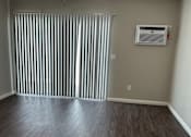 Thumbnail 21 of 35 - an empty living room with wood floors and a ceiling fan