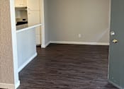 Thumbnail 33 of 35 - an empty living room with wood floors and a ceiling fan