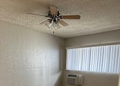 Thumbnail 29 of 35 - an empty room with a ceiling fan and a window