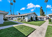 Thumbnail 9 of 35 - A row of houses with a clear blue sky above them.