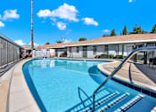 Thumbnail 2 of 35 - A swimming pool with a metal fence around it.