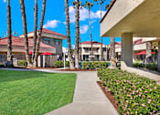 Thumbnail 11 of 23 - A building with a red roof and palm trees in front.
