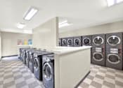 Thumbnail 23 of 23 - A row of washing machines in a laundromat.