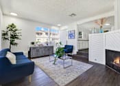 Thumbnail 12 of 27 - Modern living room with fireplace and seating at ELEVATE Apartments HOMES, Placentia