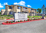 Thumbnail 1 of 27 - Property entrance sign with landscaping at ELEVATE Apartments HOMES, California