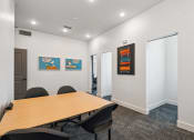 Thumbnail 3 of 25 - a conference room with a wooden table and chairs