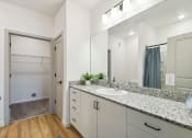 Thumbnail 23 of 25 - a bathroom with a sink and a shower and a mirror at Gibson Oaks, Lakeland, 33809