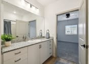 Thumbnail 22 of 25 - a bathroom with a large mirror and a sink at Gibson Oaks, Lakeland, 33809