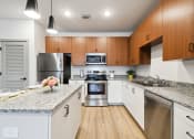 Thumbnail 20 of 25 - a modern kitchen with granite counter tops and stainless steel appliances at Gibson Oaks, Lakeland, 33809