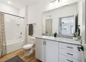 Thumbnail 15 of 25 - a bathroom with a shower toilet and sink and a mirror at Gibson Oaks, Lakeland, 33809