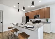 Thumbnail 13 of 25 - a kitchen with a granite counter at Gibson Oaks, Lakeland, 33809 top and a bar with stools