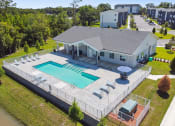Thumbnail 8 of 25 - an aerial view of a house with a swimming pool and patio furniture at Gibson Oaks, Lakeland, 33809