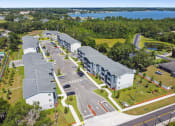 Thumbnail 24 of 25 - an aerial view of apartment buildings with a lake in the background at Gibson Oaks, Lakeland, 33809