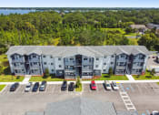 Thumbnail 25 of 25 - an aerial view of an apartment building and parking lot with cars at Gibson Oaks, Lakeland, 33809