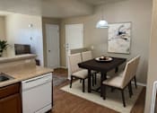 Thumbnail 3 of 18 - A kitchen with a dining table and chairs.