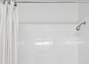 Thumbnail 16 of 32 - A white bathroom with a shower curtain and a white tub.