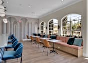 Thumbnail 46 of 57 - Clubhouse with a long couch and tables and chairs