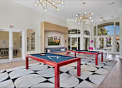 Thumbnail 42 of 57 - a game room with two ping pong tables and a television