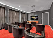 Thumbnail 54 of 57 - a large screening room with leather chairs and a television