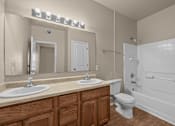 Thumbnail 17 of 18 - A bathroom with a white toilet and a white bathtub.
