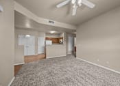 Thumbnail 15 of 18 - A spacious room with a ceiling fan and carpeted floor.