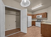 Thumbnail 18 of 18 - A kitchen with a refrigerator, microwave, and oven.