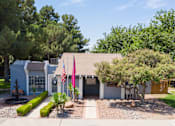Thumbnail 21 of 28 - A house with a flag and a tree in front.