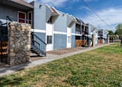 Thumbnail 26 of 28 - A row of modern townhouses with a stone pillar in front of the first one.
