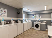 Thumbnail 20 of 28 - A laundromat with washers and dryers.