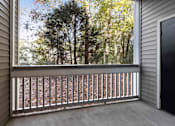 Thumbnail 15 of 50 - A view from a balcony looking out at a forest of trees.