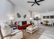 Thumbnail 5 of 50 - A living room with a red couch and a leopard print rug.