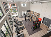 Thumbnail 15 of 43 - A gym with treadmills, exercise bikes, and a balloon arch.