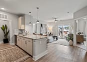 Thumbnail 27 of 43 - A modern kitchen with a large island and a dining area in the background.