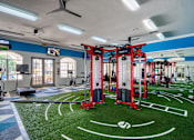 Thumbnail 48 of 57 - a gym with weights and equipment on a fake football field
