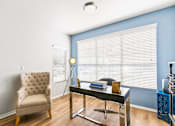 Thumbnail 17 of 57 - a living room with a chair and a glass desk