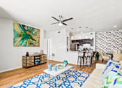Thumbnail 14 of 57 - a living room with a couch and a ceiling fan