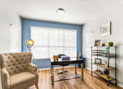 Thumbnail 18 of 57 - a living room with a large window and a couch and a table