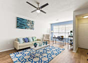Thumbnail 15 of 57 - a living room with a couch and a ceiling fan