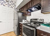 Thumbnail 5 of 57 - a kitchen with stainless steel appliances and a refrigerator