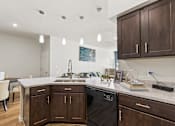 Thumbnail 6 of 57 - a kitchen with wooden cabinets and a counter top with a sink