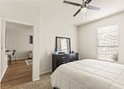 Thumbnail 22 of 57 - a bedroom with a large bed and a ceiling fan
