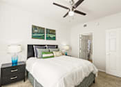 Thumbnail 21 of 57 - a bedroom with a white bed and a ceiling fan