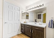 Thumbnail 24 of 57 - a bathroom with a large mirror and a sink