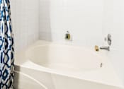 Thumbnail 26 of 57 - a white bathroom with a tub and a shower curtain