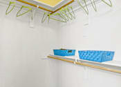 Thumbnail 28 of 57 - a laundry room with shelves and baskets on the wall