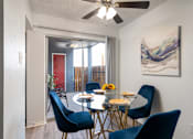 Thumbnail 6 of 28 - A dining room with a table set for four.