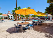 Thumbnail 40 of 57 - a group of tables with umbrellas and chairs in a pool