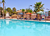 Thumbnail 36 of 57 - a swimming pool with chairs and umbrellas at a resort