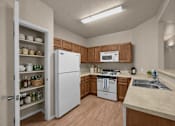 Thumbnail 8 of 18 - A kitchen with a white refrigerator, wooden cabinets, and a white stove top oven.