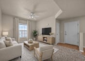 Thumbnail 4 of 18 - A living room with a grey couch, a wooden coffee table, a television, and a ceiling fan.